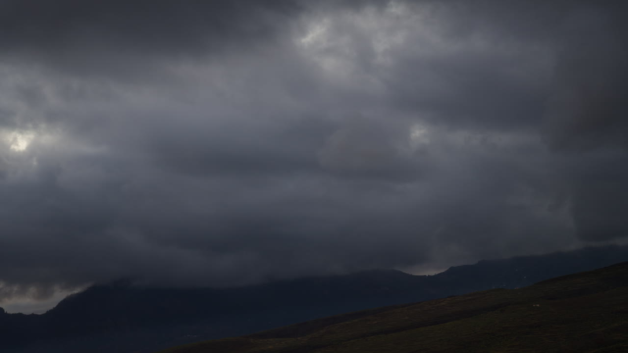 Dramatic timelapse of fast moving clouds over a mountain range in Gran canaria, canary islands, creating a captivating atmospheric effect
