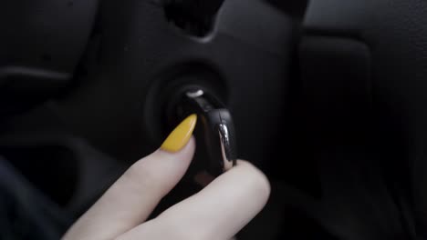 hand turning car key in ignition