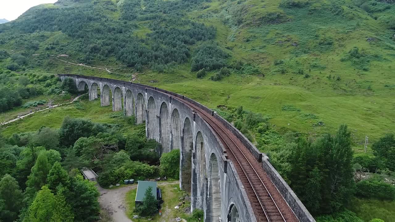 the old glenfinnan viaduct built in 1900 seen from the drone in the green glenfinnan valley in scotland