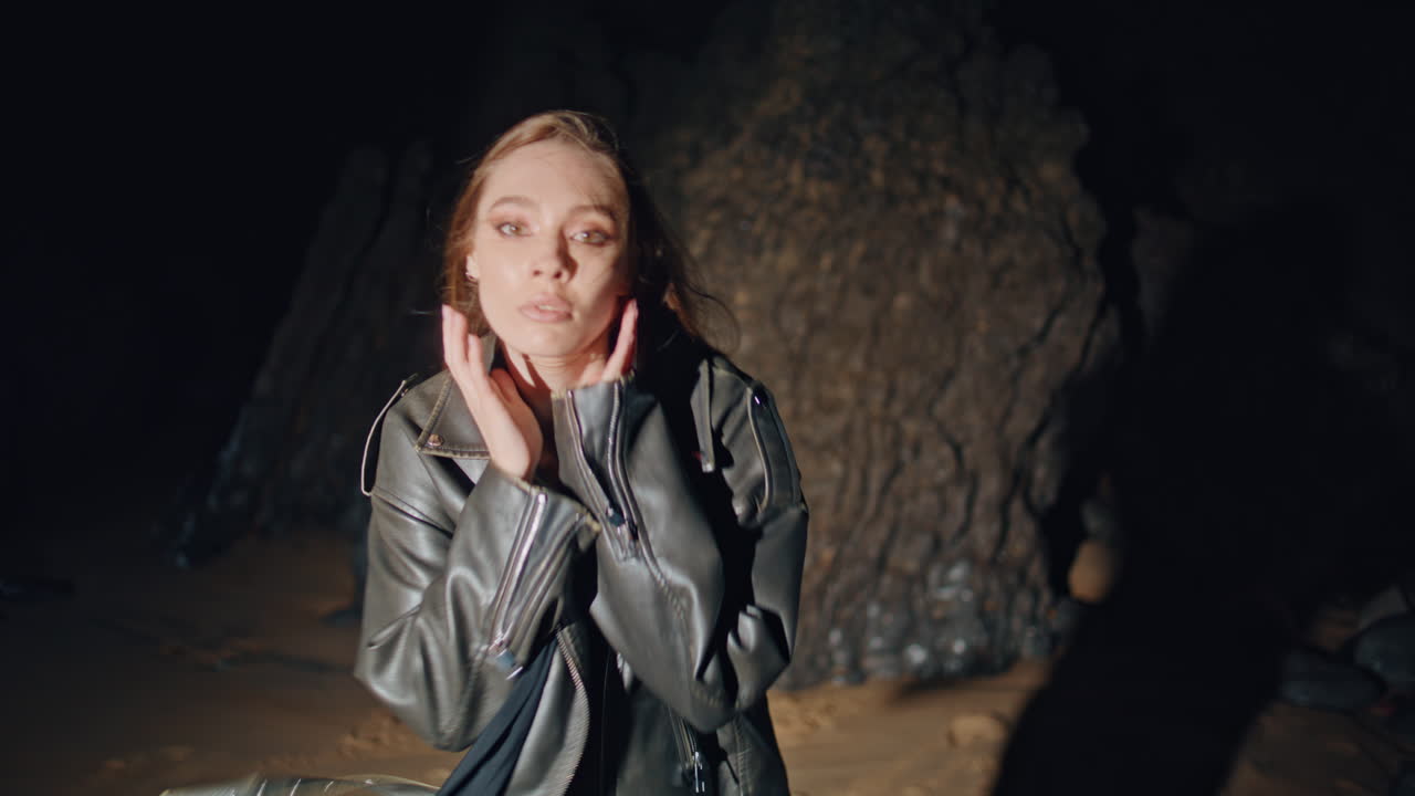 Closeup trendy woman dancing night party in light. Girl enjoying music moving