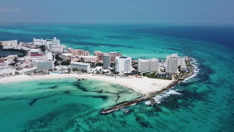 Vista-Aérea-De-Drones-De-Hoteles-Y-Complejos-Turísticos-De-Cancún-Con-Vistas-Al-Agua-Turquesa-Del-Océano,-México