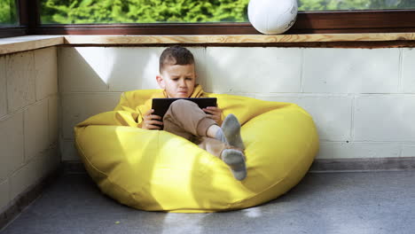 Kid-sitting-on-hassock