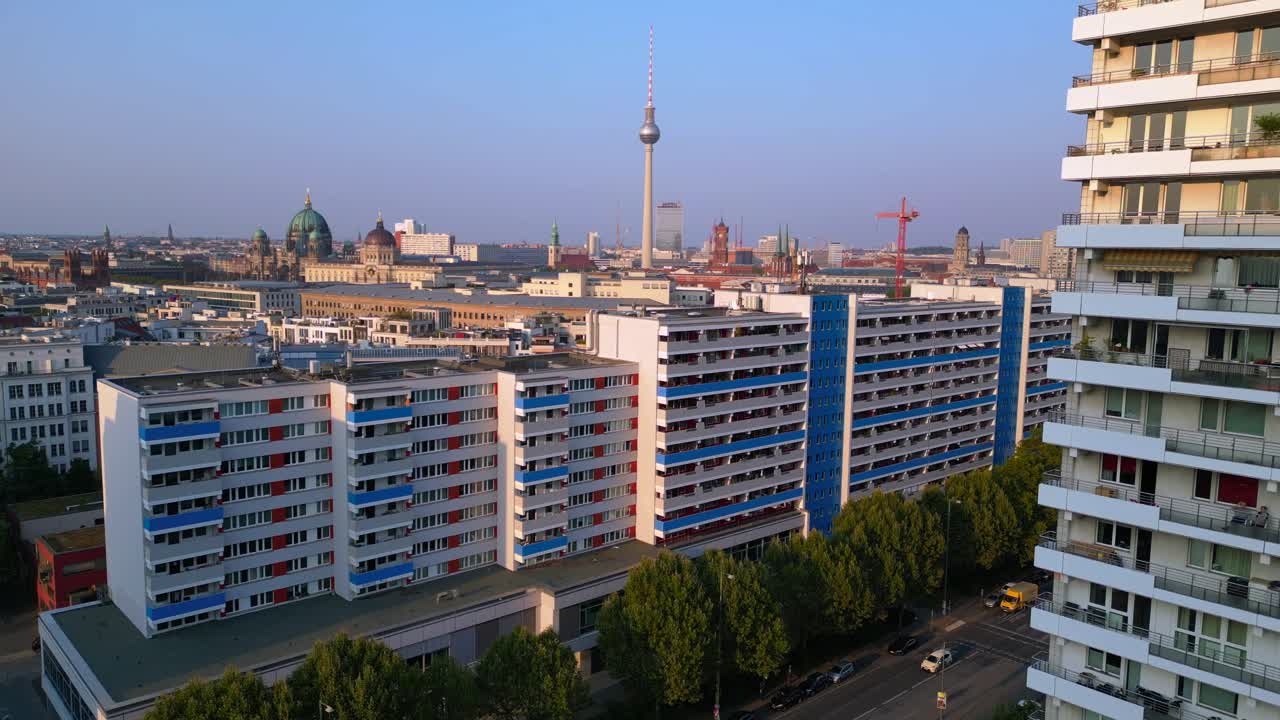 berlin cityscape with City Palac, tv tower, dom, Red town hall and Central Committee of the SED bathed in golden light. Smooth aerial view flight ascending drone