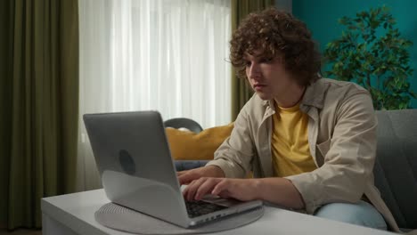 young person working on laptop at home