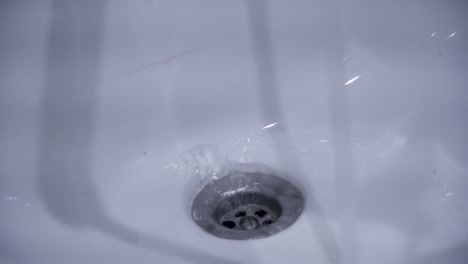 water draining into a sink