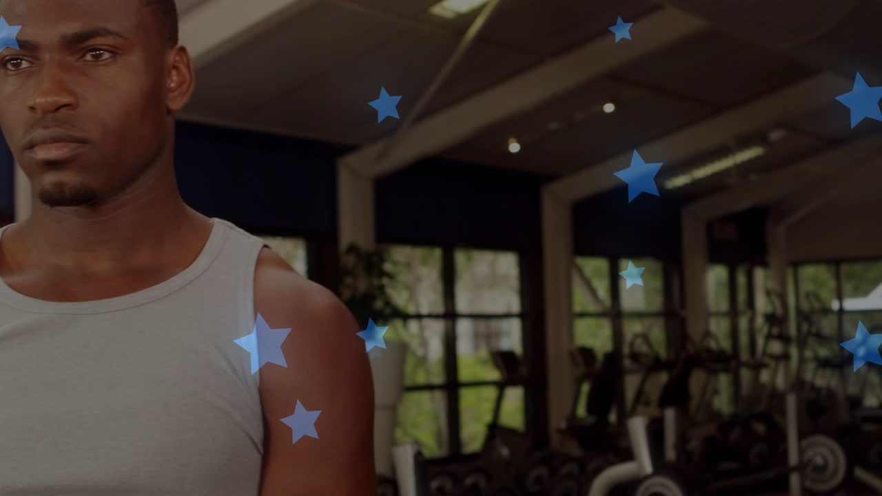 Male in gym reaching, grasping kettlebell, lifting for strength while blue star overlay drifting