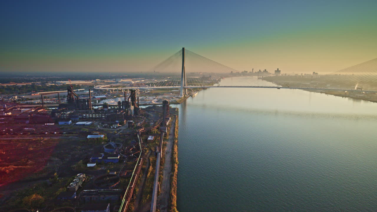 Drone footage of a cargo vessel sailing past industrial zones on the Detroit River
