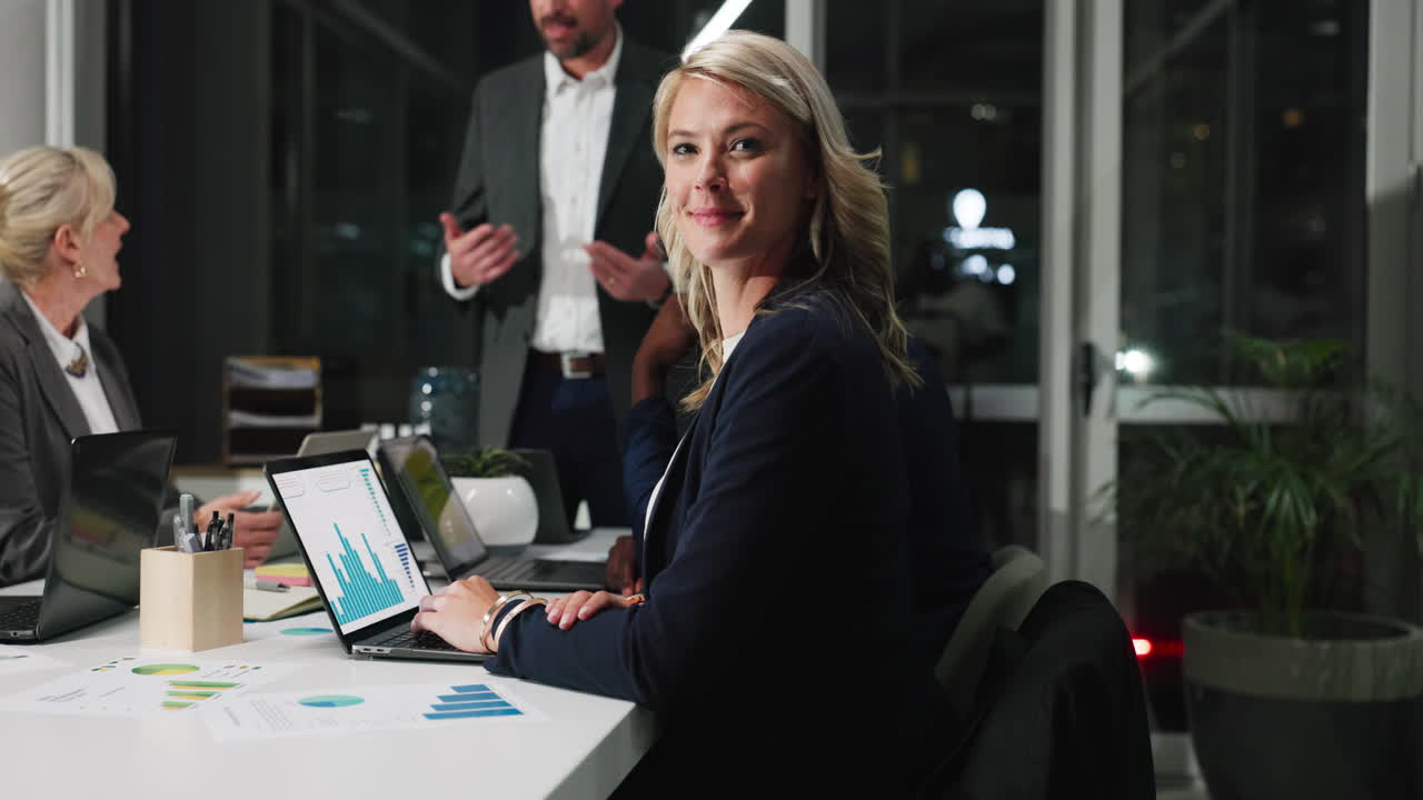 Smiling Businesswoman Working on Laptop in Corporate Meeting