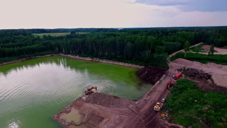 Machinery-working-in-quarry-with-artificial-pond