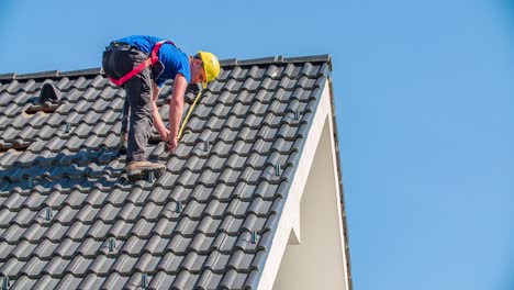 blue collar worker measuring the size of roof for solar installation