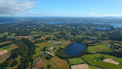 aerial panoramic drone landscape of lemuy island chiloé chilean patagonia island with green agricultural fields and skyline