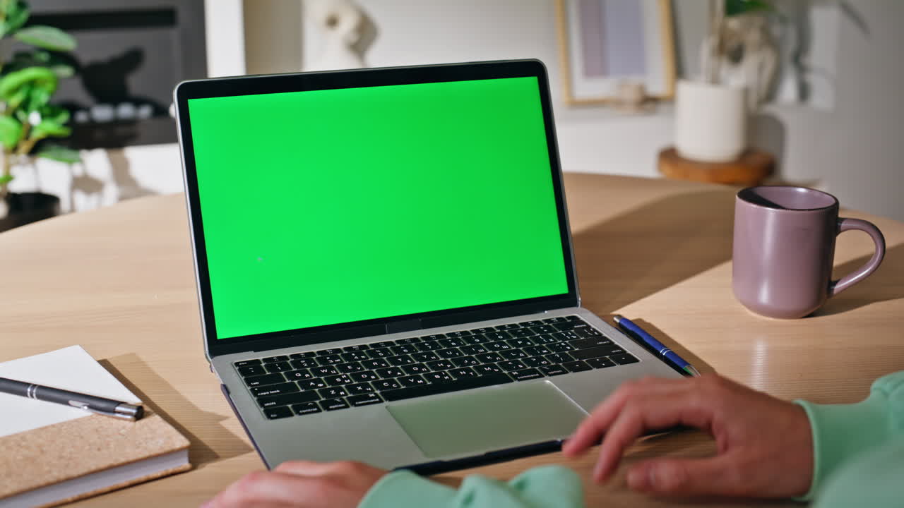 Woman hands using touchpad green screen laptop at home closeup. Unknown female