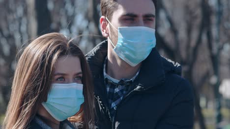 couple wearing masks outdoors