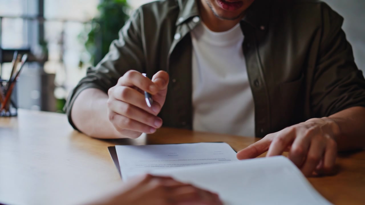 Young businessman signing contract document office meeting. Closeup hands deal