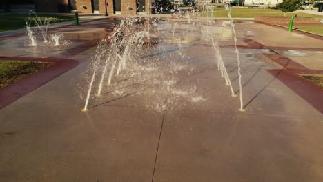 Young-Boy-Splashing-Playing-Through-Water-Tunnel-at-a-Splash-Pad