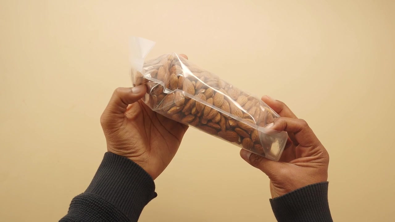 Top View of Hands Holding a Bag of Raw Almonds