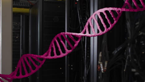 animation of pink dna strand moving over dark computer servers