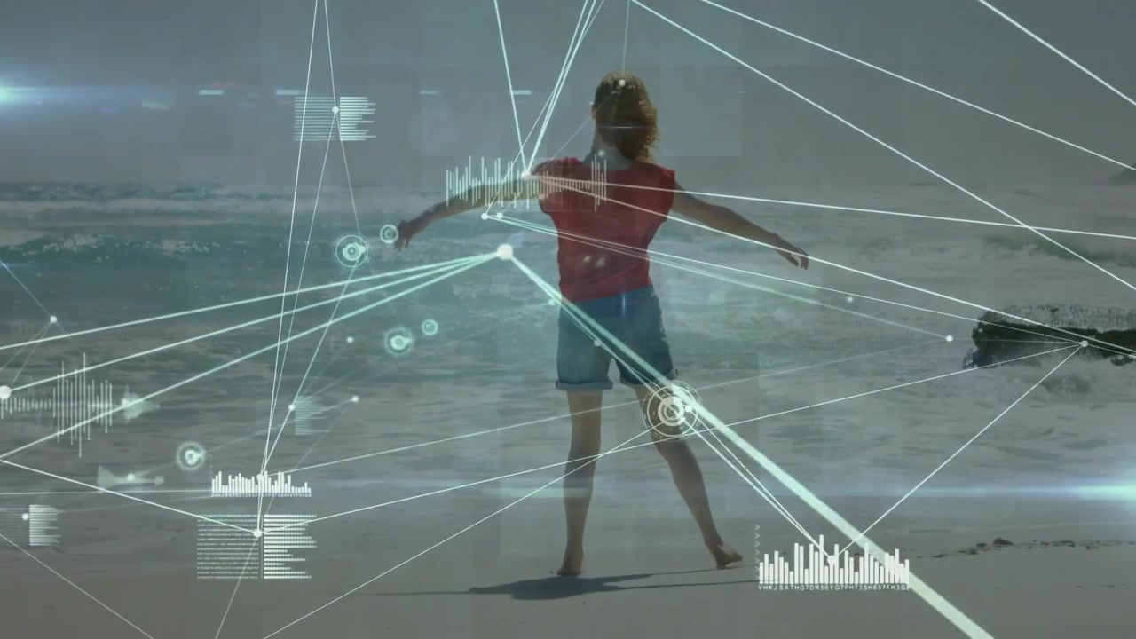 woman walking along wet sand, activating digital data graphics tracking limbs in technology demo