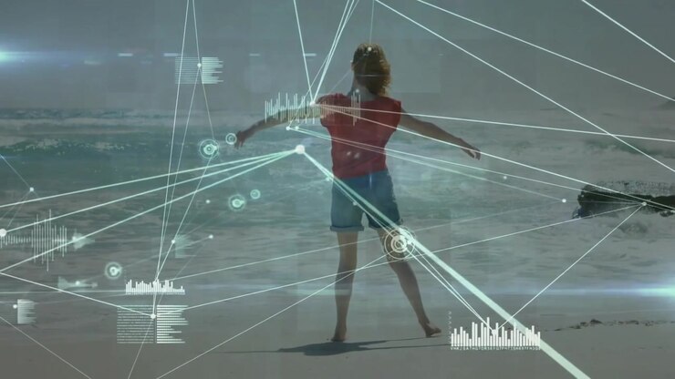 woman walking along wet sand, activating digital data graphics tracking limbs in technology demo