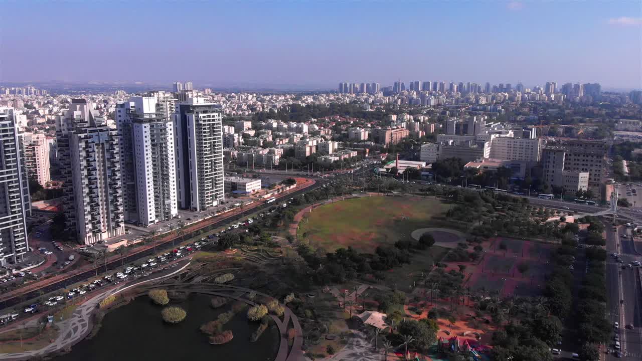 Aerial view of a modern city with skyscrapers and a large park