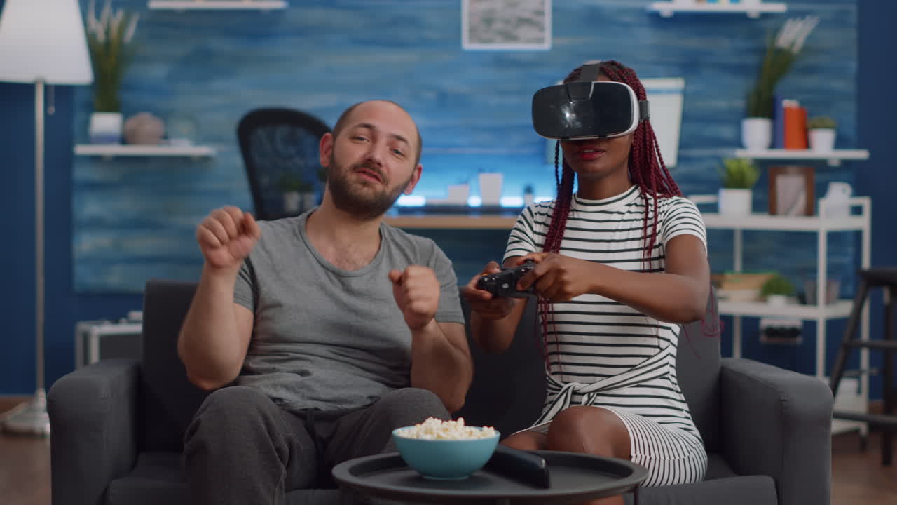 Married interracial couple using technology at home
