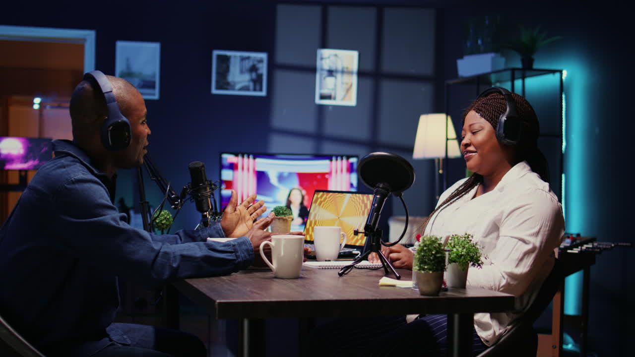 Influencer unboxing tech product for review, recording podcast with guest in studio