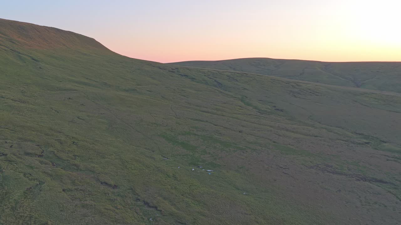 Beautiful aerial view at sunset behind mountain hill with Sabre plane wreck, Peak district, UK