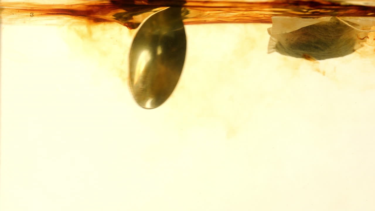Boiling  tea bag water stirring with a spoon