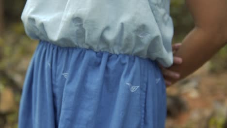 Cinematic-closeup-of-a-fashion-model-wearing-a-blue-and-white-dress-in-the-tropical-rainforest-of-Goa-India-in-Slow-Motion,-Slomo