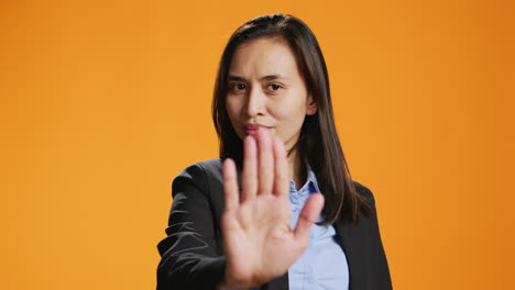 filipino woman showing stop sign with palm