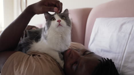 Pet-owner-with-his-cat-on-bed