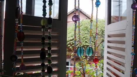 beads curtain hanging on the wooden window wall