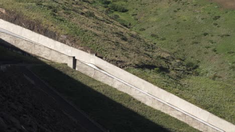 Camera-pans-down-long-spillway-chute-flowing-with-flood-water-release