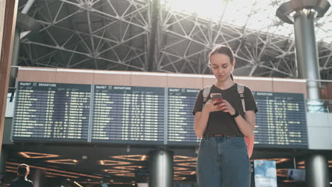 A-young-woman-is-online-check-in-to-Board-the-plane.-Booking-a-car-through-the-smartphone-app.-Car-sharing-services-from-your-smartphone.-Hotel-reservation-via-phone