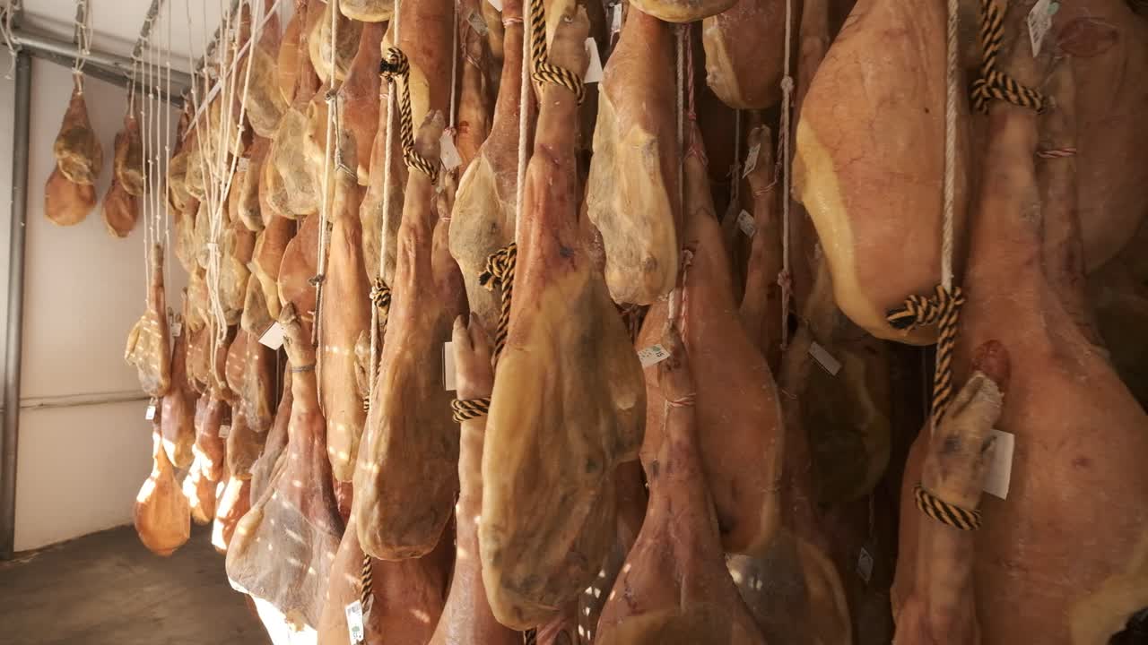 Jamon serrano pig legs factory hanging in a industry. Iberian ham elaboration process