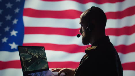 US-Air-Force-dispatcher-looking-at-surveillance-transmission,-United-States-flag