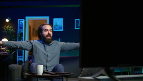 excited man at home enjoying football competition, clapping hands