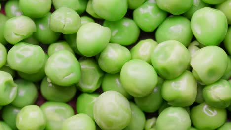 close up of raw green peas rotating in а circle