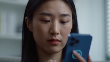 a young woman intently examines her smartphone, immersed in a digital experience, as she navigates through various apps and interacts with the virtual environment.