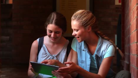 happy students sitting using tablet pc