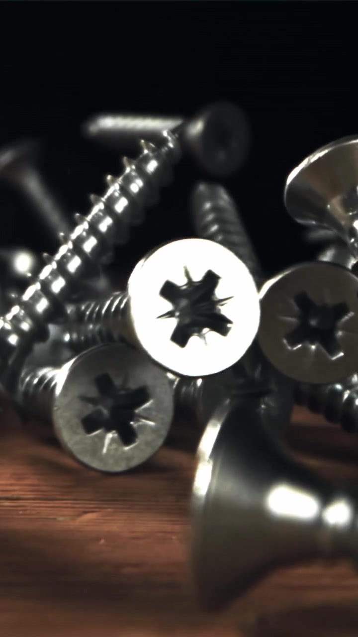 Slow Motion Metal Screws Falling onto a Wooden Surface