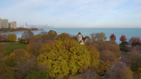 drone flying away from colorful tree in autumn