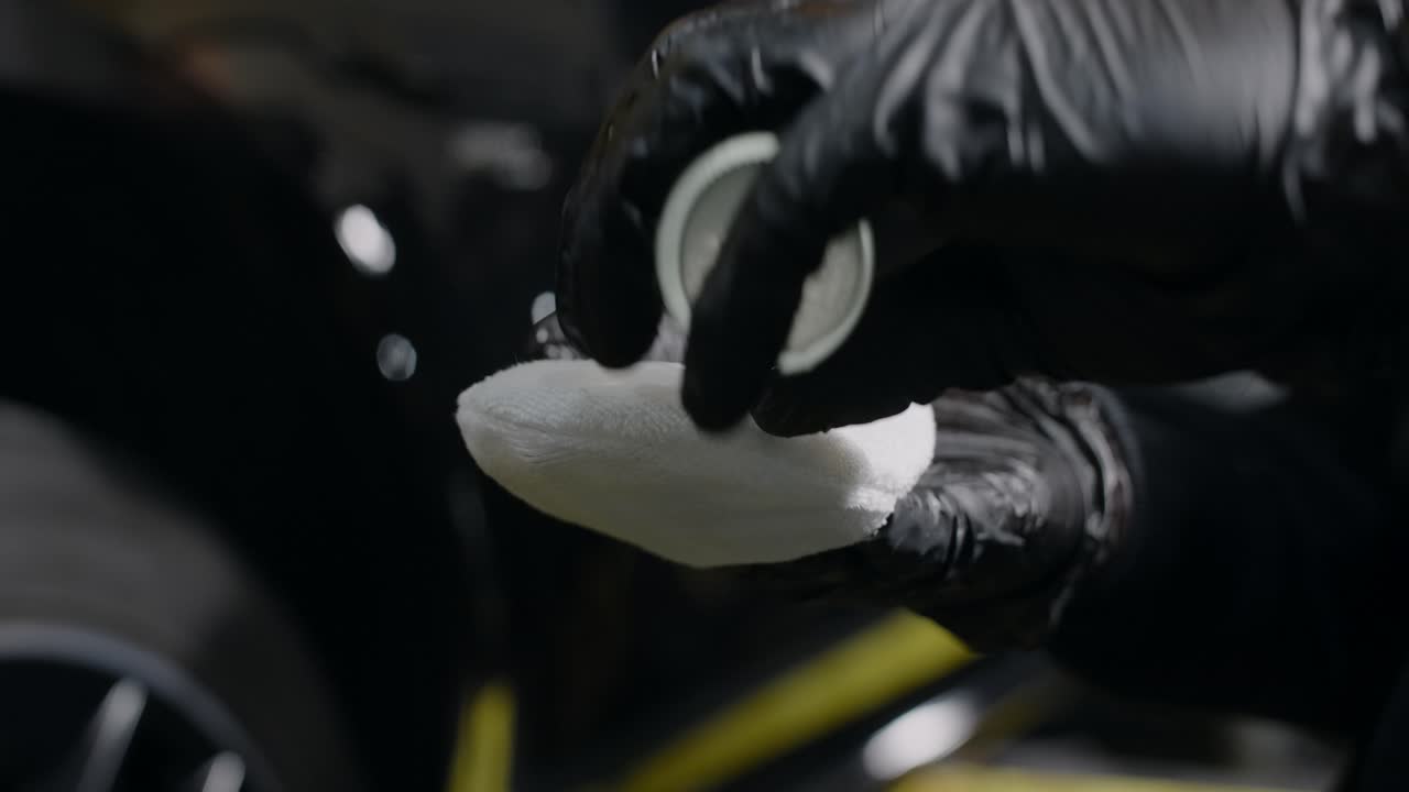 Car Detailing Process: Applying Liquid to Cleaning Cloth
