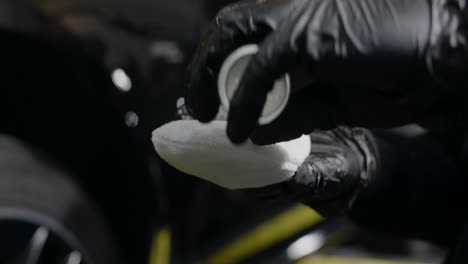 car detailing process: applying liquid to cleaning cloth