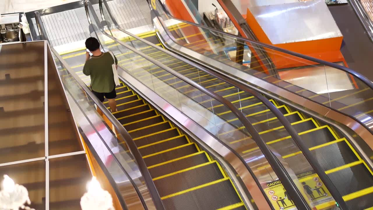 Poeple Using Escalators In Shopping Mall