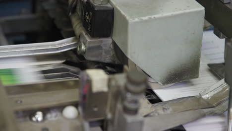 close up of flyers on conveyor of a printing machine in a print shop