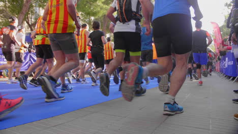 marathon start view from behind of runners legs and shoes montpellier sunny day