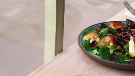 baked goats cheese and pear salad by a window, pan