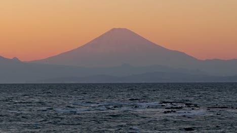 beautifully silhouetted mt. fuji during orange dusk