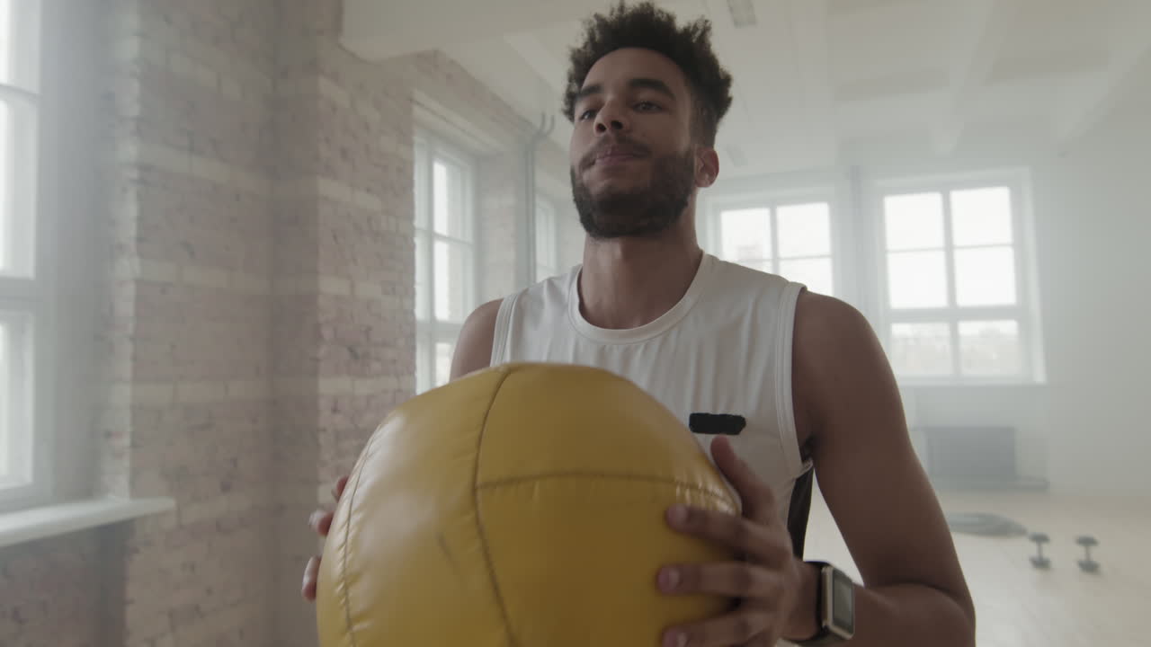 Sportsman Doing Squats With Weight Ball